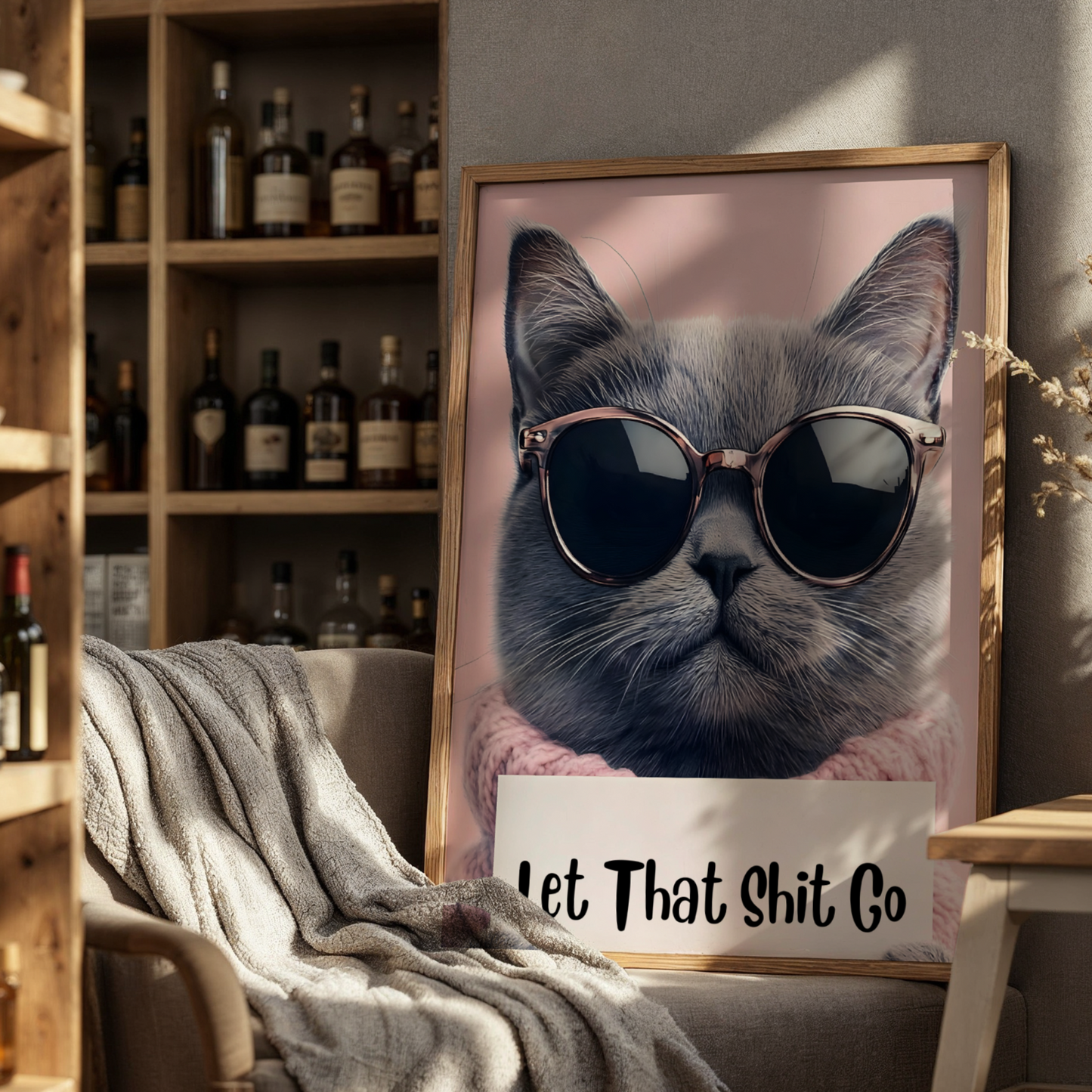 Framed picture of a cat wearing sunglasses with text in a cozy room.